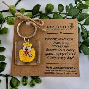 Keyring with a handpainted funny yellow bird on it.